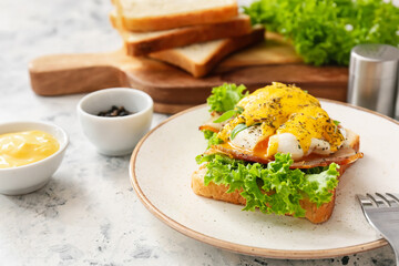 Plate with tasty egg Benedict on table