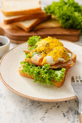 Plate with tasty egg Benedict on table