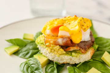 Plate with tasty egg Benedict on table, closeup