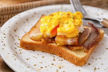 Plate with tasty egg Benedict on table, closeup