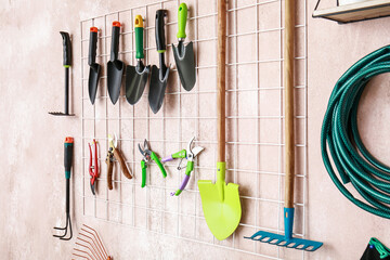 Different gardening supplies hanging on wall