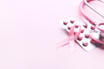 Pink ribbon, remedy and stethoscope on color background. Breast cancer awareness concept