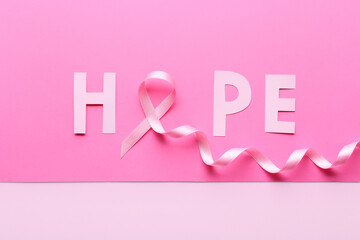 Pink ribbon and word HOPE on color background. Breast cancer awareness concept