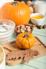 Ingredients for preparing pumpkin pie on color wooden background