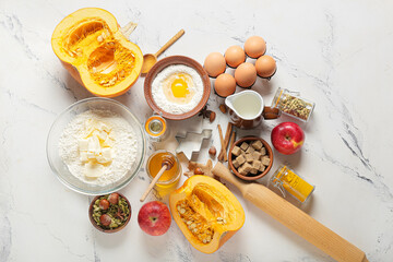 Ingredients for preparing pumpkin pie on white background