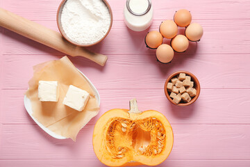 Ingredients for preparing pumpkin pie on color wooden background