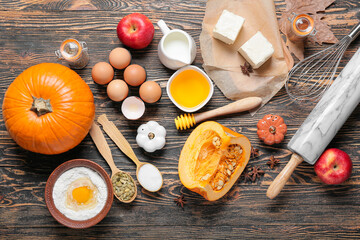 Ingredients for preparing pumpkin pie on wooden background