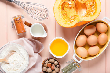 Ingredients for preparing pumpkin pie on color wooden background