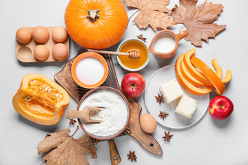 Ingredients for preparing pumpkin pie on light background