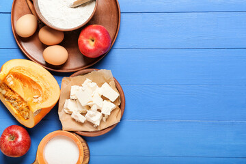 Ingredients for preparing pumpkin pie on color wooden background