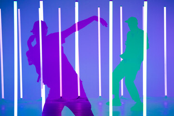 Collage of shadows handsome person doing hip hop elements on neon lamps background. Close up man dancing at party in night club. Dance school poster.