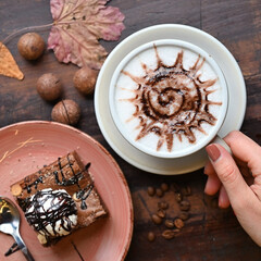 Freshly brewed cup of coffee with cake