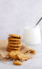 Cereal cookies on rustic plate with milk.