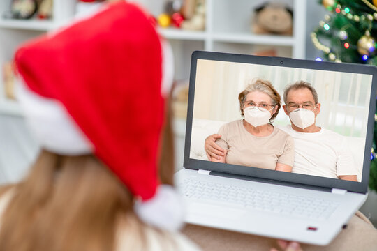 Young woman wearing santa hat, take video calls during coronavirus pandemic. Celebrating Christmas with family via the Internet during quarantine Coronavirus