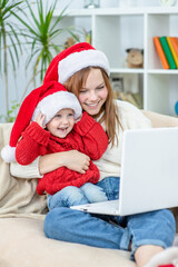 Happy family meets Christmas (New Year) through a video call with relatives during pandemic coronavirus