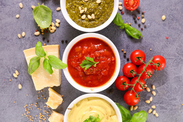 collection of sauce- tomato sauce, pesto sauce and mustard