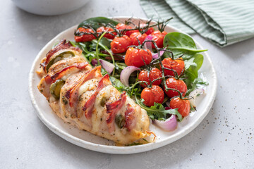 Baked hasselback chicken breast stuffed with bacon, cheese and jalapenos