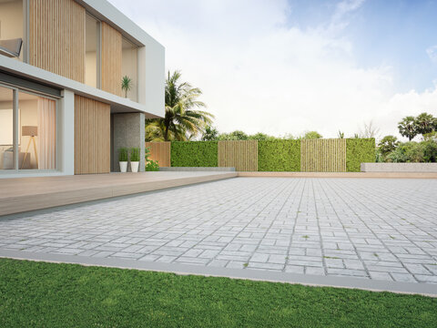 New house with empty cobblestone floor for car park. 3d rendering of green grass lawn in modern home.