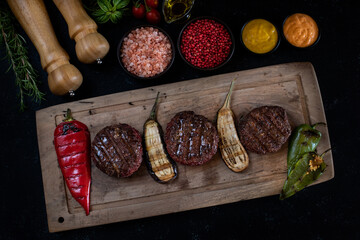 Delicious grilled meat in the plate with dark background