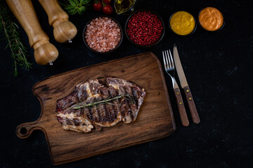 Delicious grilled meat in the plate with dark background
