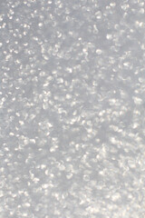White and grey glitter bokeh circle glow blurred and blur abstract. Glittering shimmer bright luxury. White and silver glisten twinkle for texture wallpaper and background backdrop.
