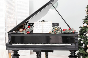 Interior of room with grand piano decorated for Christmas