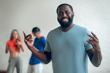 Man explaining a dance routine to his colleagues