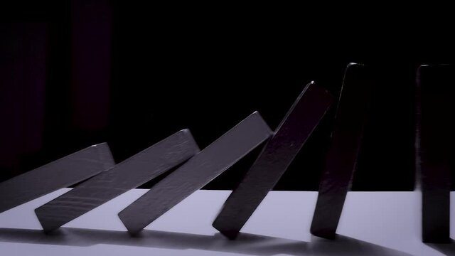 Falling domino color block slow motion. Falling and collapse concept. Monotone shot