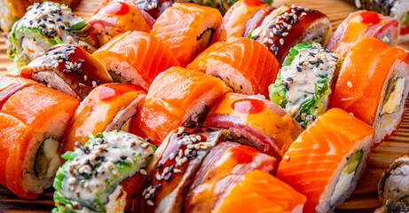 set of sushi roll with salmon, avocado, cream cheese, cucumber, rice, tuna