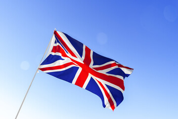Flag of Great Britain waving against blue sky