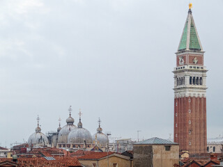 Fototapeta na wymiar St Mark's Campanile and Basilica (Basilica e Campanile di San Marco) above the roofs - Venice, Veneto, Italy
