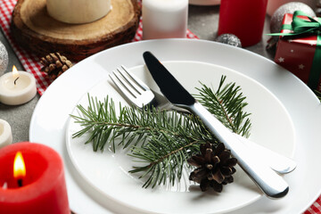 Concept of New year table setting with candles on gray table