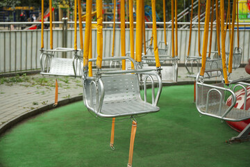 Empty swings of carousel in attraction park