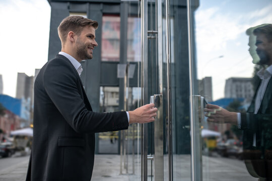 Young businessman entering the business center by pass card
