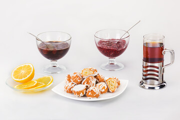 appetizing cakes with tea, jam and fragrant lemon