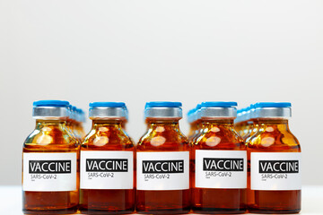 Sars-cov-2 vaccine vial bottles on white table