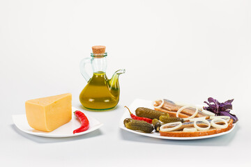 Delicious herring with salted cucumbers, pepper and olive oil
