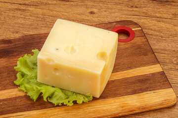 Emmental cheese over wooden board