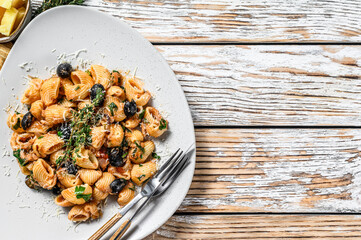 Pasta  puttanesca with tuna fish, tomatoes, garlic and black olives. White background. Top view. Copy space