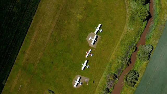Drone shot above propeller aircraft, at a hobby, Ultralight aviation airfield, in Scandinavia - screwdriver, aerial view