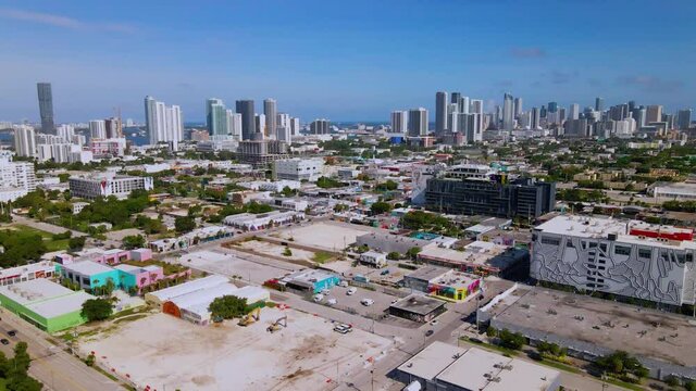 Aerial view over the Wynwood area, towards downtown high rise in Miami, Florida, sunny day  - rising,tilt, drone shot