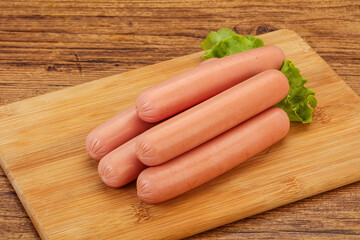 Tasty meat sausages over board