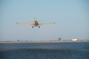 Plane sowing rice in the waterlogged field.