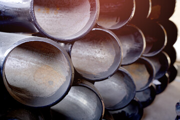 Black metal pipes and adapters of different diameters for gasification or water supply. Industrial...