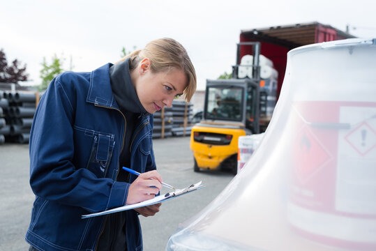 portrait of a delivery clerk inspecting product