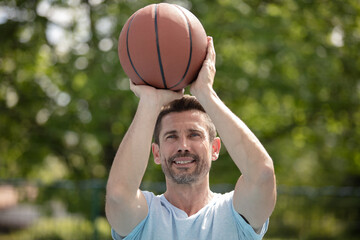 handsome male playing basketball outdoor