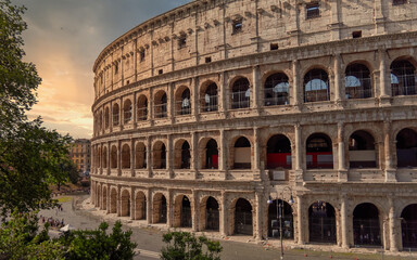 Fototapeta na wymiar Colosseum ancient arena during sunrise with impressive sky, Rome Italy