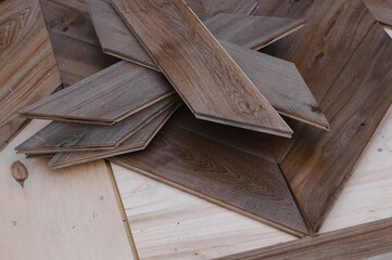 Man laying parquet flooring - closeup on male hands. worker joining parquet floor