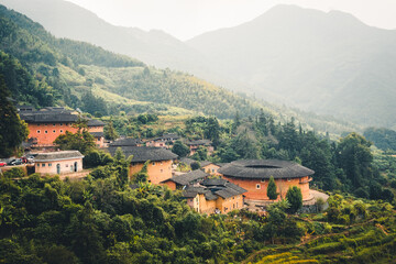 Fototapeta na wymiar aerial view of Tianluokeng Tulou cluster with mist,located in Fujian,China