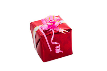 A gift box wrapped in red boom and tied with a pink ribbon. Isolated.